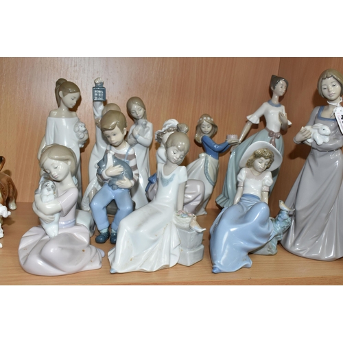 407 - A GROUP OF NAO FIGURES, to include a girl holding a rabbit, five children holding puppies, a girl ho... 