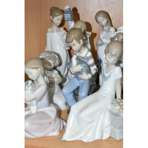 407 - A GROUP OF NAO FIGURES, to include a girl holding a rabbit, five children holding puppies, a girl ho... 