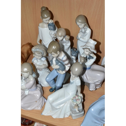 407 - A GROUP OF NAO FIGURES, to include a girl holding a rabbit, five children holding puppies, a girl ho... 