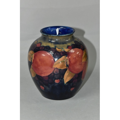 419 - A MOORCROFT POTTERY BALUSTER VASE, tube lined Pomegranate pattern on a navy blue ground, painted and... 