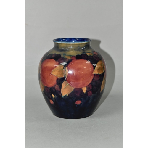 419 - A MOORCROFT POTTERY BALUSTER VASE, tube lined Pomegranate pattern on a navy blue ground, painted and... 