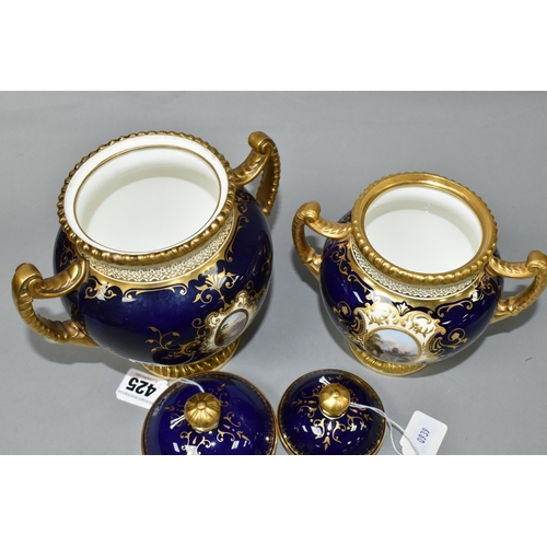 425 - TWO EARLY 20TH CENTURY COALPORT TWIN HANDLED VASES AND COVERS, blue, pale yellow and gilt ground, th... 