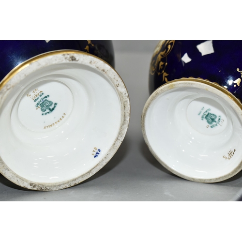 425 - TWO EARLY 20TH CENTURY COALPORT TWIN HANDLED VASES AND COVERS, blue, pale yellow and gilt ground, th... 