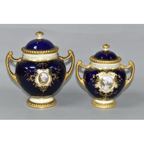 425 - TWO EARLY 20TH CENTURY COALPORT TWIN HANDLED VASES AND COVERS, blue, pale yellow and gilt ground, th... 