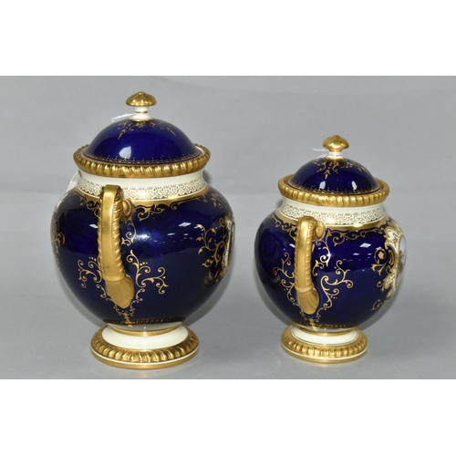 425 - TWO EARLY 20TH CENTURY COALPORT TWIN HANDLED VASES AND COVERS, blue, pale yellow and gilt ground, th... 