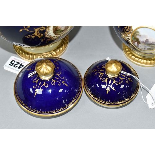 425 - TWO EARLY 20TH CENTURY COALPORT TWIN HANDLED VASES AND COVERS, blue, pale yellow and gilt ground, th... 