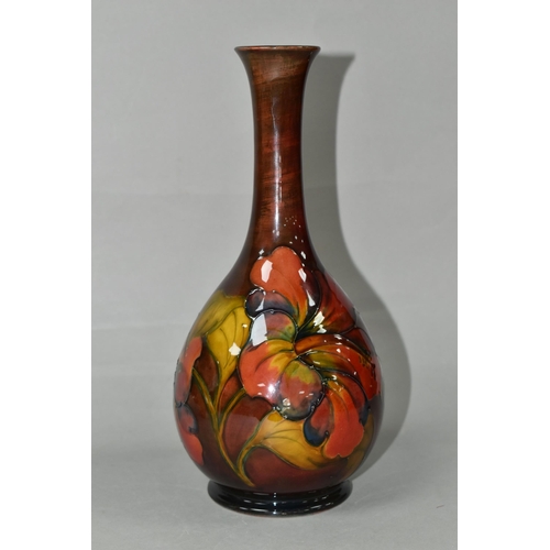 435 - A MOORCROFT POTTERY FLAMBÉ HIBISCUS PATTERN VASE, with an elongated neck, tube lined pink, yellow an... 