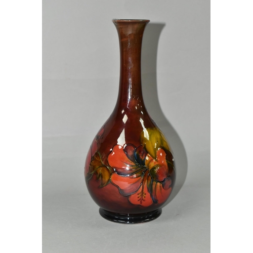 435 - A MOORCROFT POTTERY FLAMBÉ HIBISCUS PATTERN VASE, with an elongated neck, tube lined pink, yellow an... 