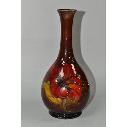 435 - A MOORCROFT POTTERY FLAMBÉ HIBISCUS PATTERN VASE, with an elongated neck, tube lined pink, yellow an... 