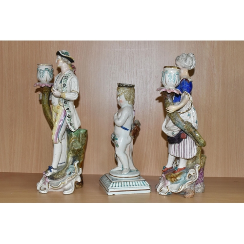 452 - A PAIR OF PORCELAIN FIGURAL CANDELABRA, blue painted marks to the base, together with a cherub candl... 