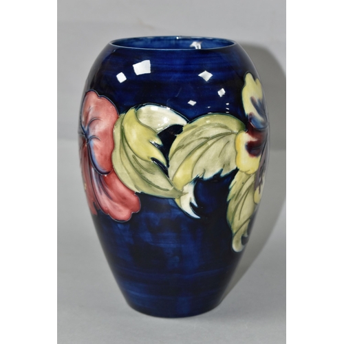 453 - A MOORCROFT POTTERY VASE, of baluster form with a mauve and yellow Hibiscus pattern on a blue ground... 