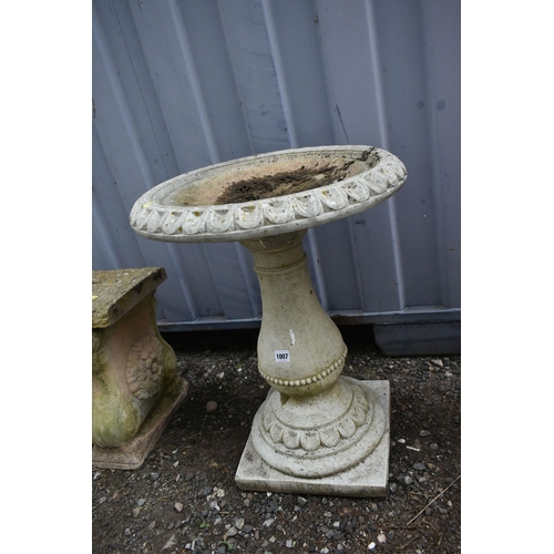 1007 - A COMPOSITE BIRDBATH, with a circular top, on a bulbous plinth with a square base, diameter 51cm x h... 