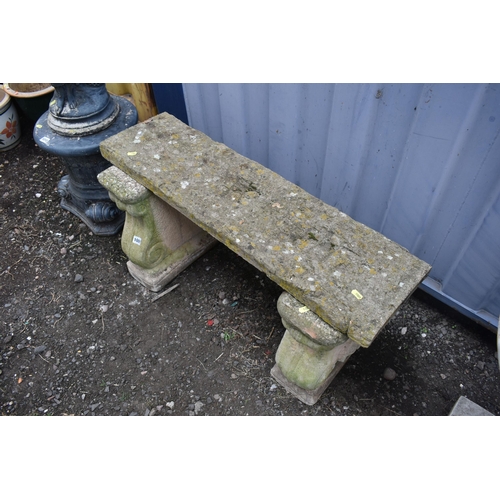 1009 - A COMPOSITE TWIN PEDESTAL GARDEN BENCH, the legs with a floral crest to the centre, length 90cm x de... 