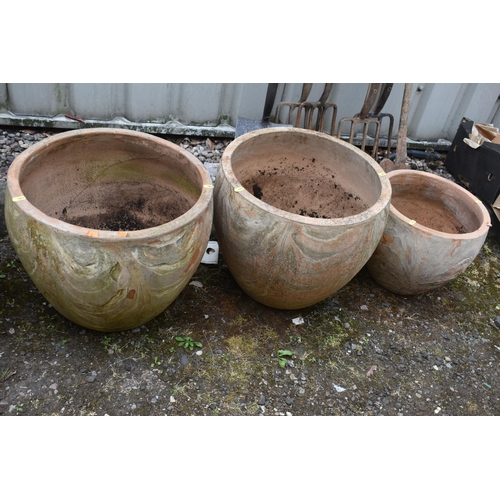 1011 - THREE LARGE TERRACOTTA GARDEN POTS, diameter 50cm x height 40cm, along with a pair of smaller terrac... 