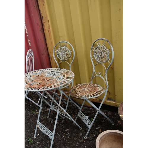 1015 - A WROUGHT IRON FOLDING THREE PIECE GARDEN BISTRO SET, comprising an oval table, with pierced foliate... 