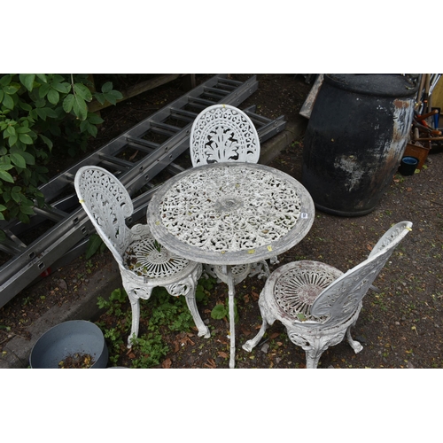 1022 - A WHITE PAINTED ALUMINIUM GARDEN BISTRO SET, comprising a circular table, with pierced foliate detai... 