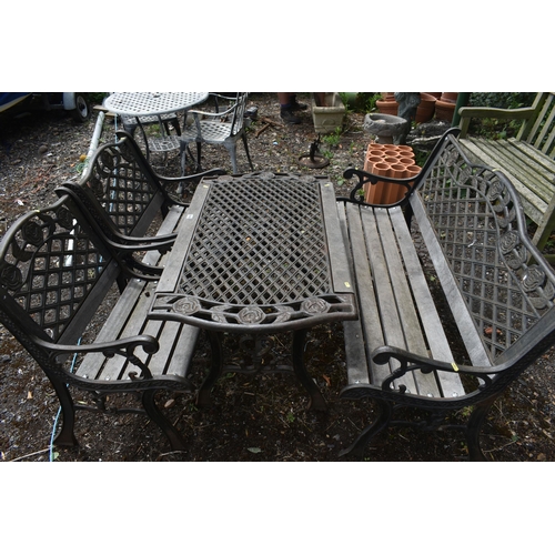 1036 - A CAST IRON AND WOODEN FOUR PIECE GARDEN SUITE, comprising a table, with rose detail to each end, le... 