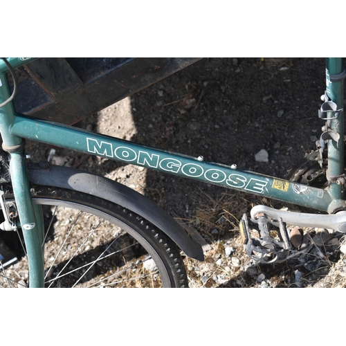 1043 - A GREEN GENTS MONGOOSE BICYCLE, with a 22inch frame and two rear bags (condition - handles sticky, h... 