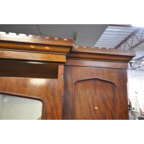 1201 - A VICTORIAN FLAME MAHOGANY TRIPLE DOOR COMPACTUM WARDROBE, the outer doors flanking a central mirror... 