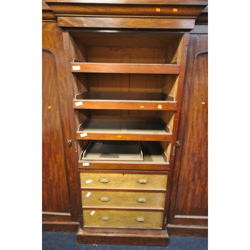 1201 - A VICTORIAN FLAME MAHOGANY TRIPLE DOOR COMPACTUM WARDROBE, the outer doors flanking a central mirror... 