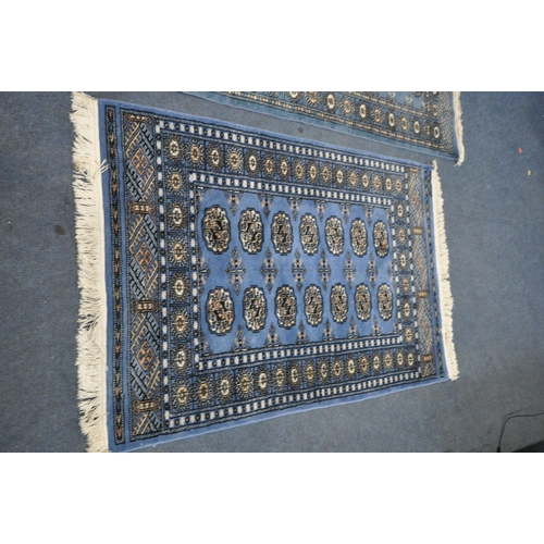 1225 - A WOOLLEN TEKKE RUG, with a blue field, 145cm x 99 cm, and a similar carpet runner 183cm x 63cm, alo... 