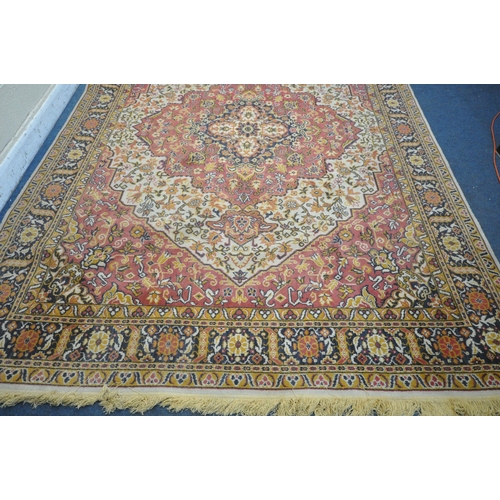 1227 - A LARGE WOOLLEN HEREKE TYPE RUG, with a red and a cream field, 348cm x 251cm (condition report: - in... 