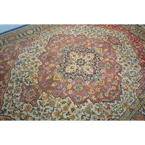 1227 - A LARGE WOOLLEN HEREKE TYPE RUG, with a red and a cream field, 348cm x 251cm (condition report: - in... 