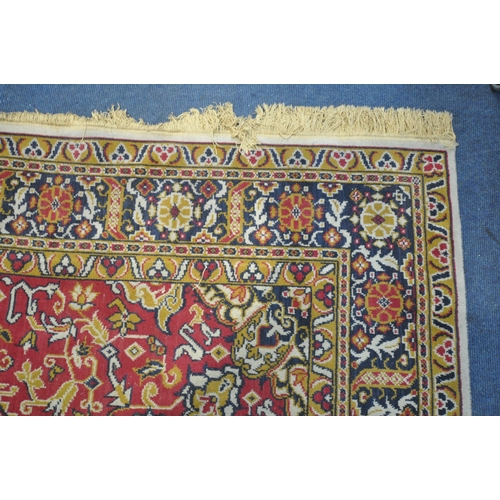 1227 - A LARGE WOOLLEN HEREKE TYPE RUG, with a red and a cream field, 348cm x 251cm (condition report: - in... 