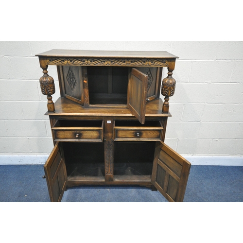 1235 - A REPRODUCTION CARVED OAK COURT CUPBOARD, with two drawers and three cupboards, width 110cm x depth ... 