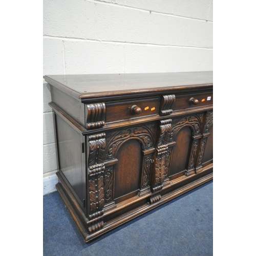 1236 - A REPRODUCTION CARVED OAK SIDEBOARD, with three drawers over four doors, width 180cm x depth 58cm x ... 