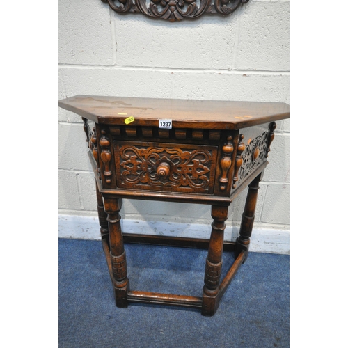 1237 - A G T RACKSTRAW OAK SIDE TABLE, with carved drawer and canted corners, on turned legs, united by str... 