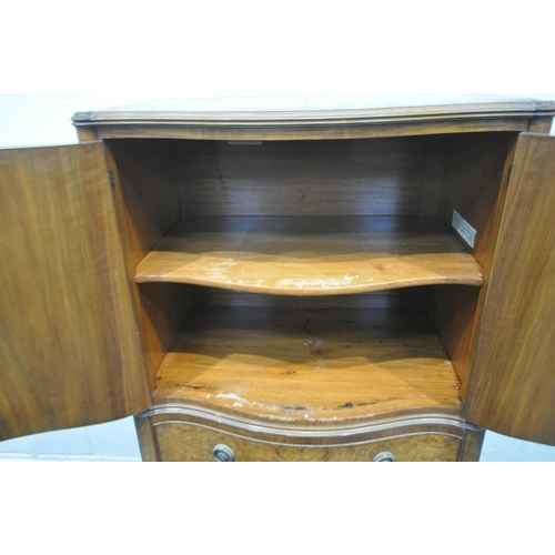 1253 - A REPRODUCTION BURR WALNUT SERPENTINE TALLBOY, with two cupboard doors enclosing a single shelf, abo... 