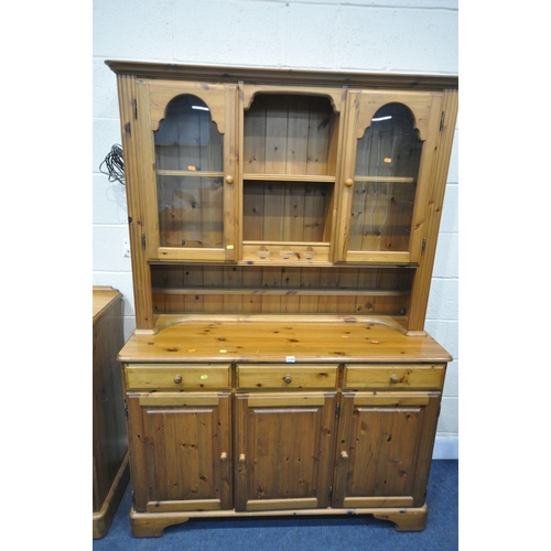 1259 - A DUCAL PINE DRESSER, the top with two glazed doors, flanking a central shelving section, the base w... 