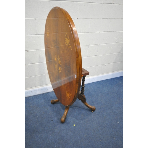 1273 - A VICTORIAN WALNUT AND MARQUETRY INLAID OVAL TILT TOP LOO TABLE, with four foliate carved legs, leng... 