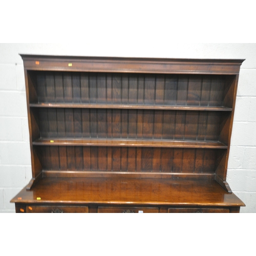 1279 - A REPRODUCTION SOLID OAK DRESSER, the top with a two tier plate rack, the base with three drawers ab... 