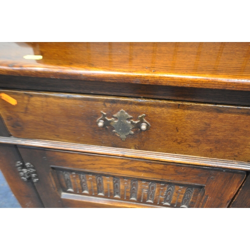 1279 - A REPRODUCTION SOLID OAK DRESSER, the top with a two tier plate rack, the base with three drawers ab... 