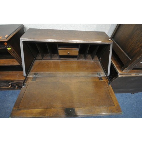 1280 - A 20TH CENTURY OAK LINENFOLD BUREAU, the fall front door enclosing a fitted interior, above four dra... 