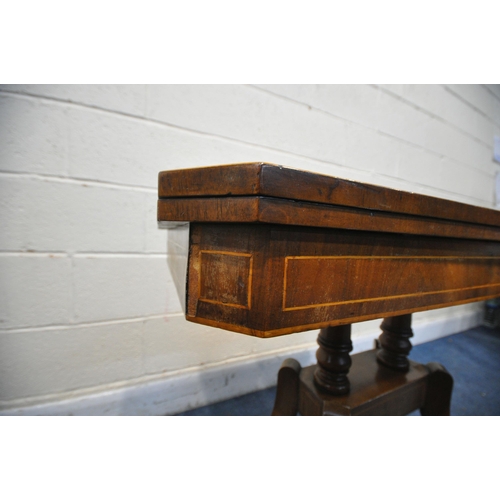 1296 - A DISTRESSED GEORGIAN WALNUT FOLD OVER GAMES TABLE, on twin turned supports, on splayed legs and bra... 