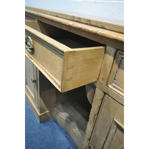 1320 - A VICTORIAN PINE KNEEHOLE DESK, with a red and tooled leather writing surface, three drawers, above ... 