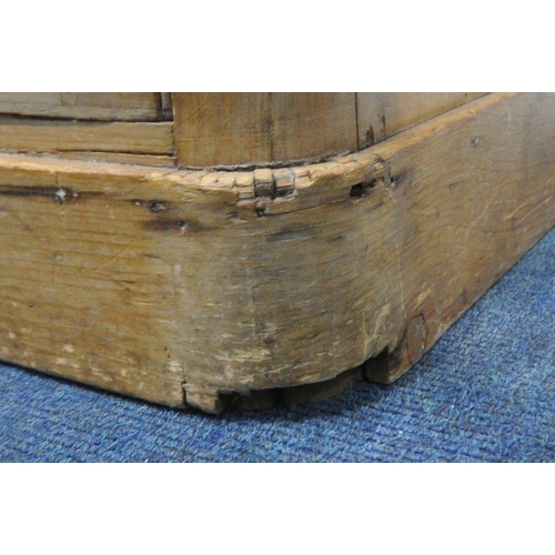 1320 - A VICTORIAN PINE KNEEHOLE DESK, with a red and tooled leather writing surface, three drawers, above ... 