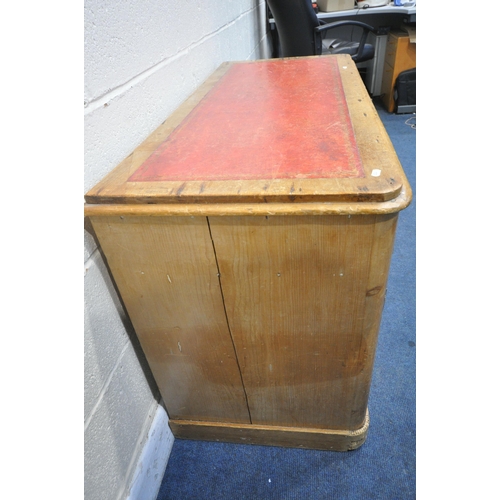 1320 - A VICTORIAN PINE KNEEHOLE DESK, with a red and tooled leather writing surface, three drawers, above ... 