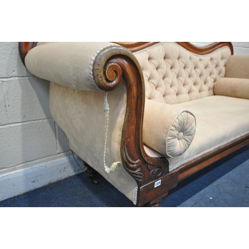 1328 - A VICTORIAN WALNUT THREE SEATER SOFA, with a shaped back, scrolled armrests, on turned legs and bras... 