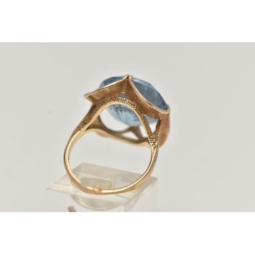 20 - A 9CT GOLD GEM SET DRESS RING, set with a circular cut light blue stone assessed as synthetic spinel... 