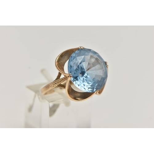 20 - A 9CT GOLD GEM SET DRESS RING, set with a circular cut light blue stone assessed as synthetic spinel... 