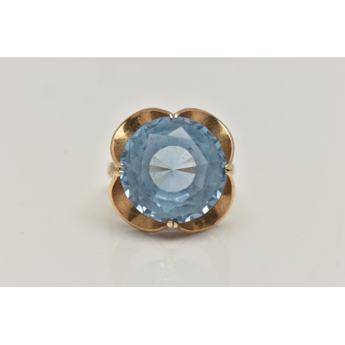 20 - A 9CT GOLD GEM SET DRESS RING, set with a circular cut light blue stone assessed as synthetic spinel... 