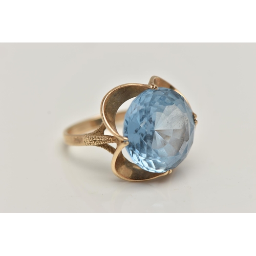 20 - A 9CT GOLD GEM SET DRESS RING, set with a circular cut light blue stone assessed as synthetic spinel... 