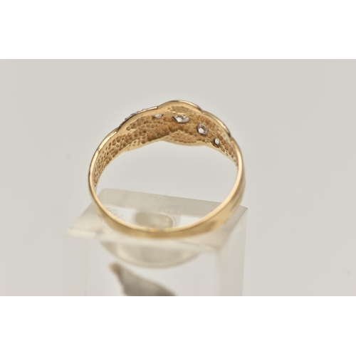 32 - A 9CT GOLD CUBIC ZIRCONIA SET RING, designed with an asymmetrical row of graduated colourless, cubic... 