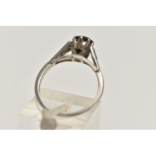 53 - A WHITE METAL GEM SET RING, a circular cut sapphire in a prong setting, leading on to tapered should... 