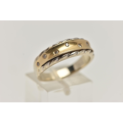 69 - A BICOLOUR AND DIAMOND RING, seven round brilliant cut diamonds, flush set in yellow metal, with a w... 