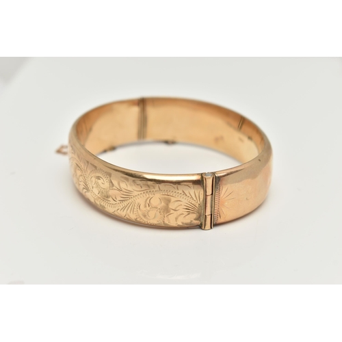 8 - A 9CT GOLD HINGED BANGLE, foliage pattern to one side, fitted with a push piece clasp with additiona... 